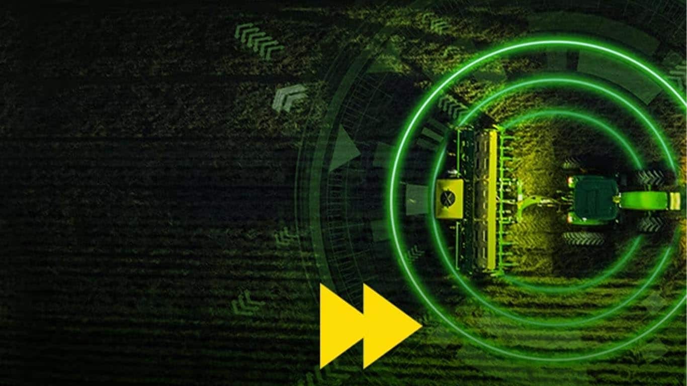 Máquina John Deere vista de cima funcionando, uma versão circular verde na parte superior, com uma seta amarela