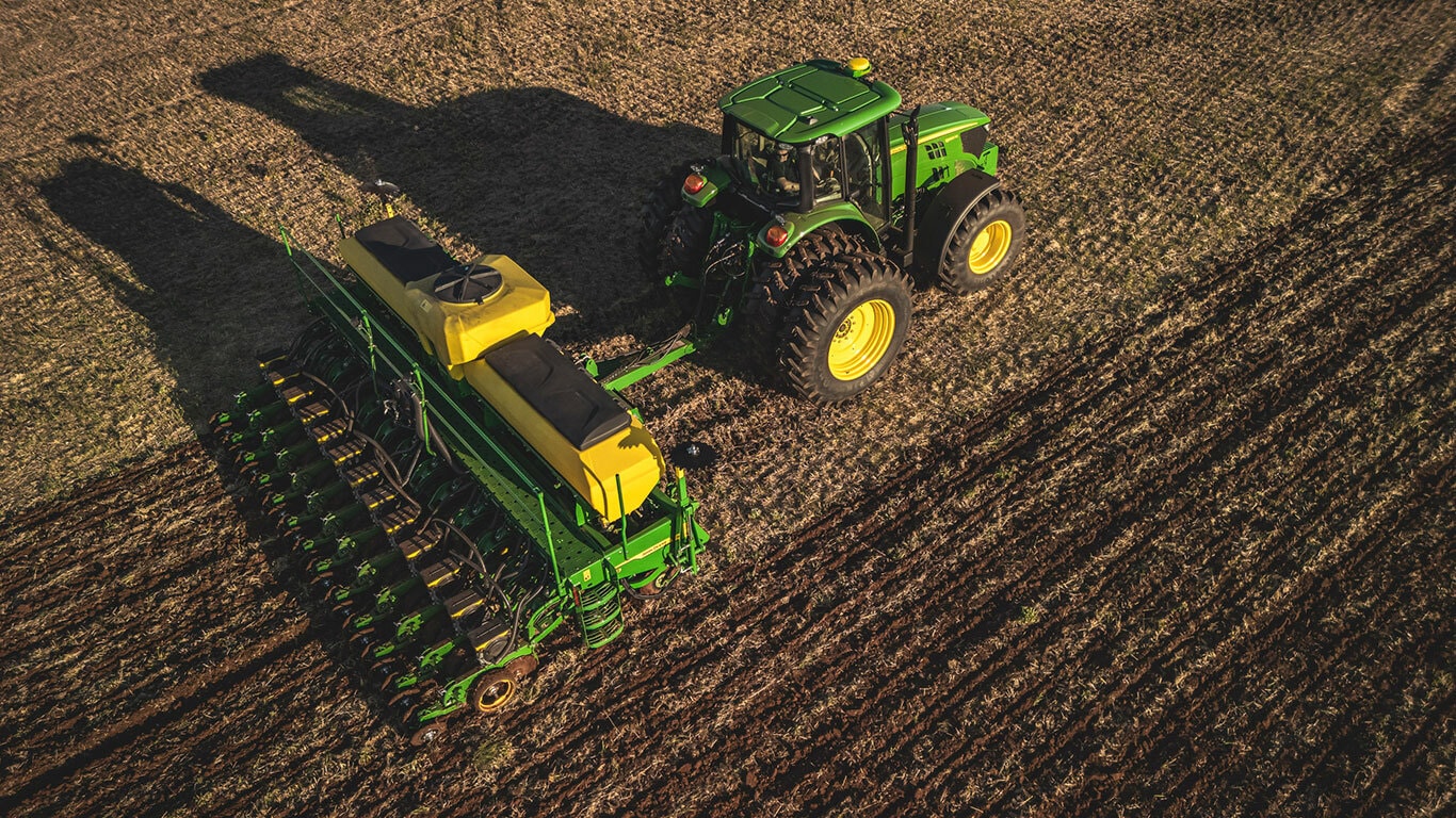 Máquina John Deere série 1200 no campo.